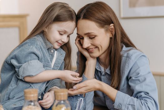 A touching moment between a mother and daughter sharing smiles indoors.